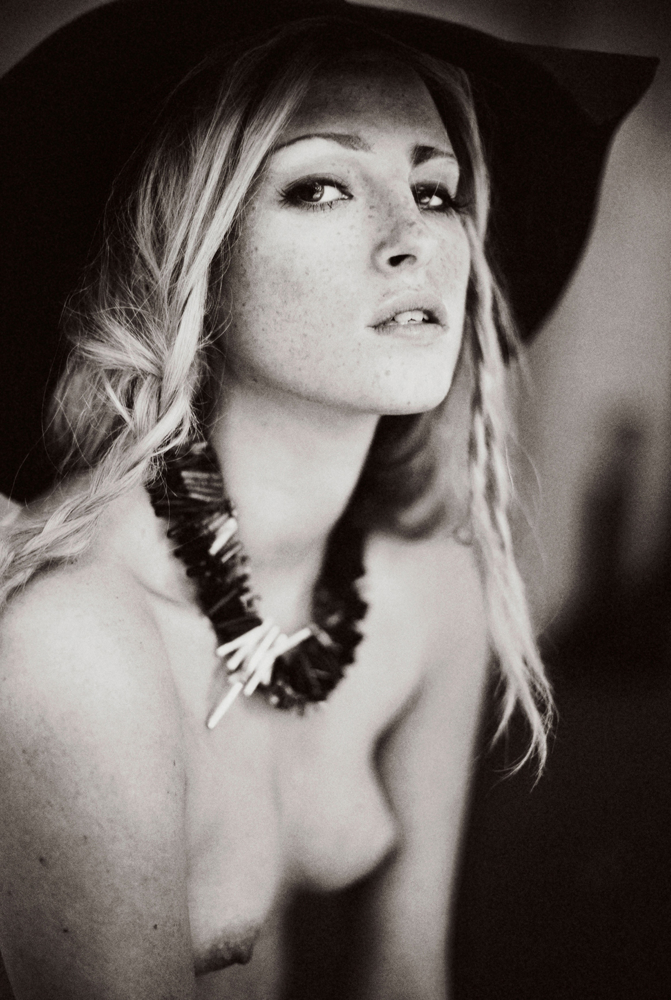 black and white photograph of semi nude female model in the studio wearing irish contemporary design jewellery