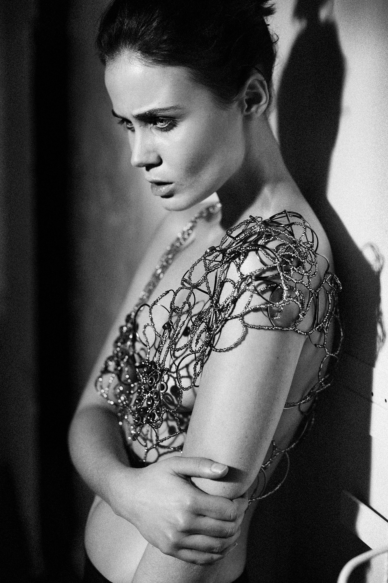 black and white photograph of semi nude female model in the studio wearing irish contemporary design jewellery