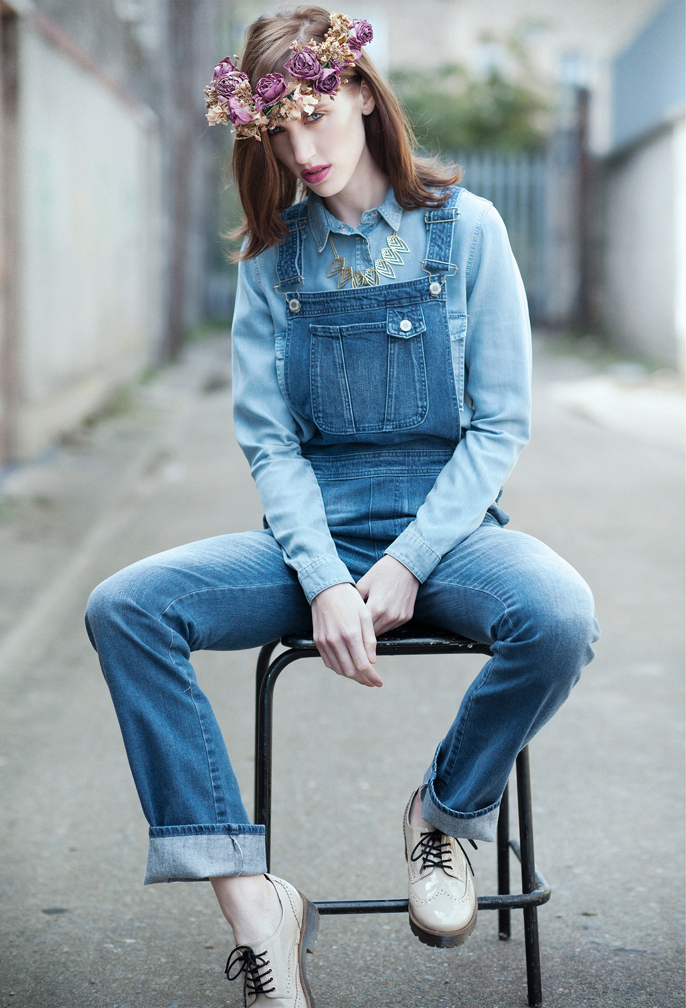 model seating on the cahir wearing denim clothes with flower crown